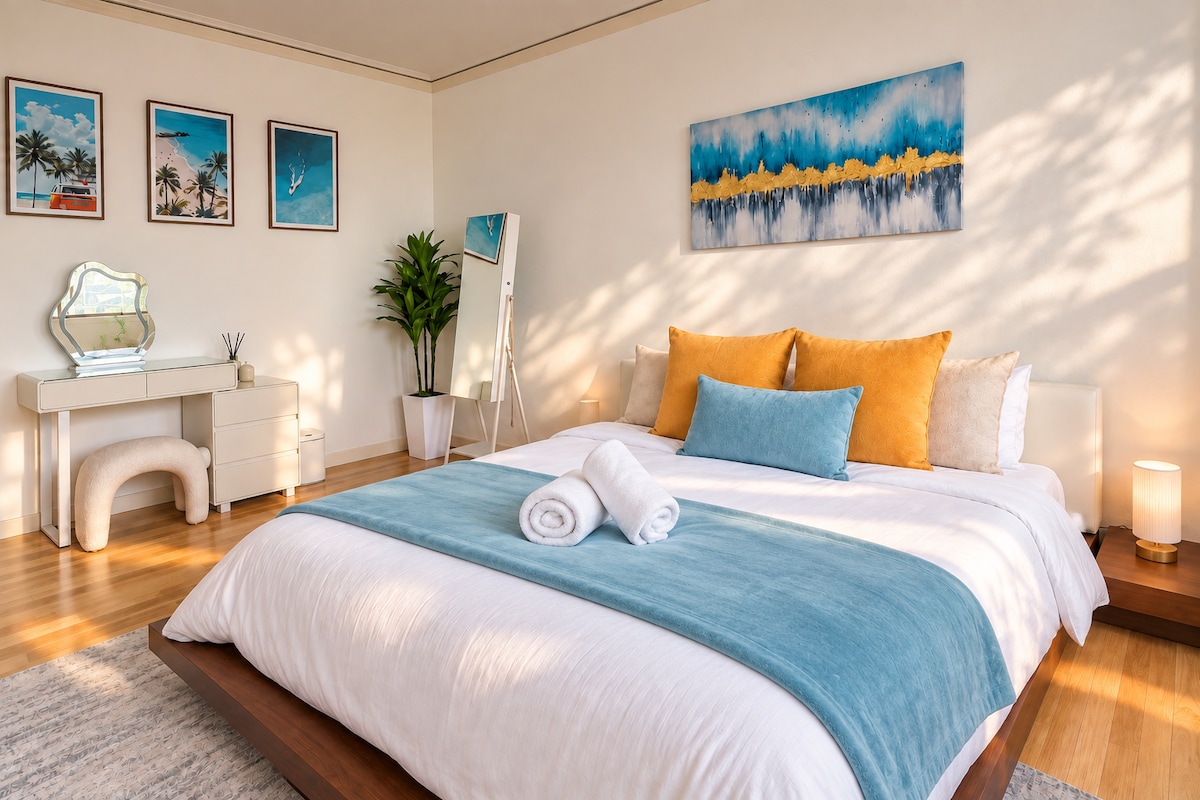 Queen bedroom with teal and gold accents