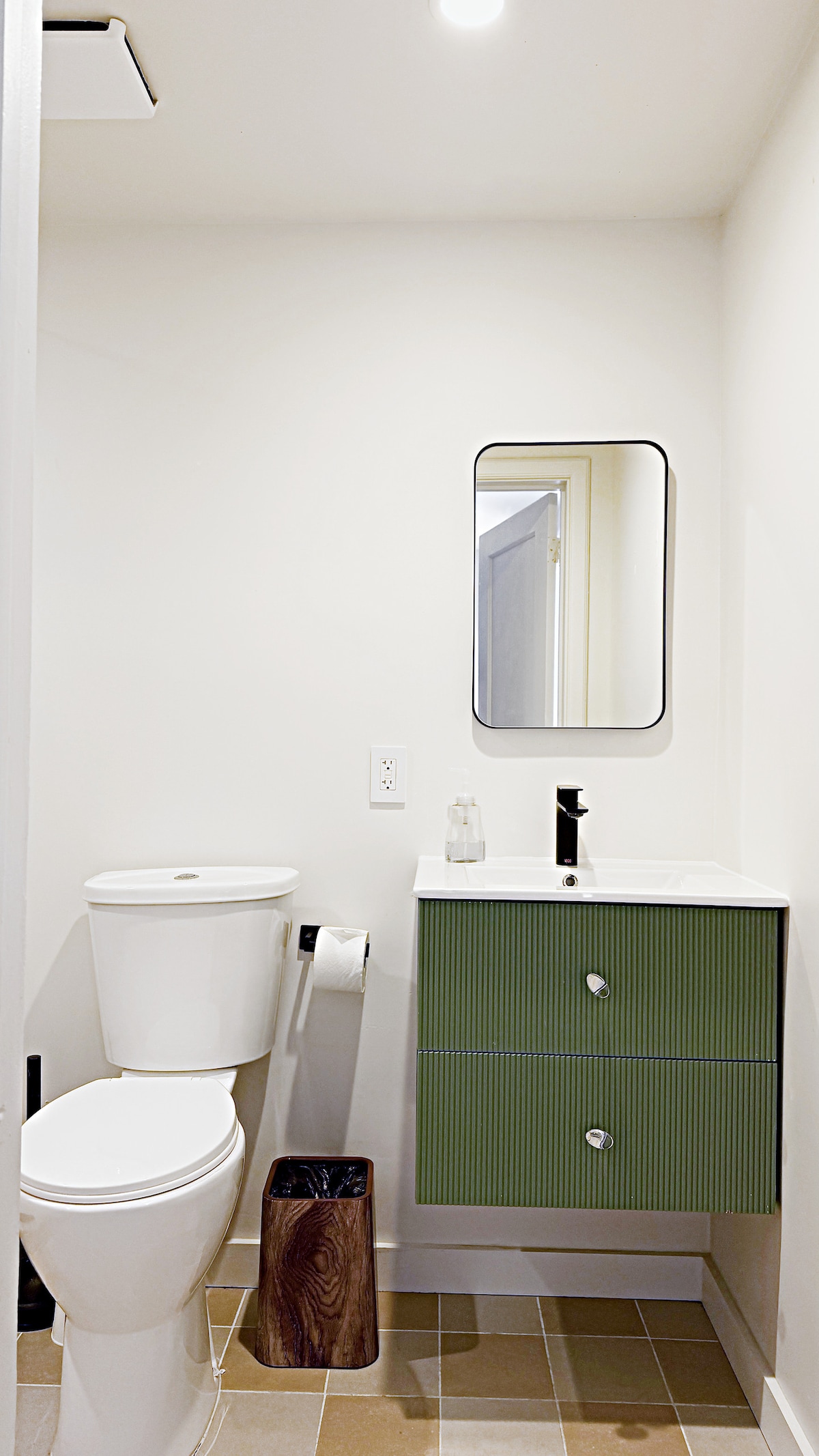 Bathroom vanity and toilet in the sunny suite