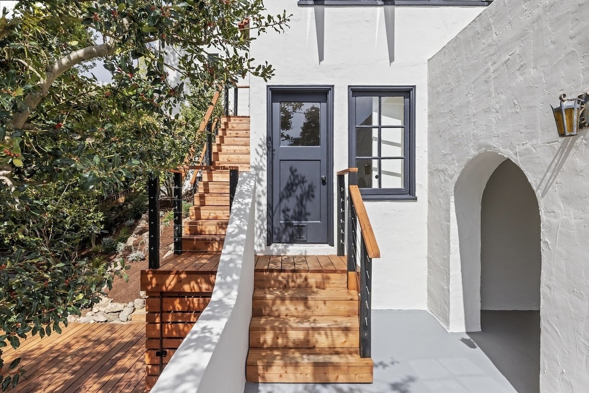Exterior private entrance with wood stairs